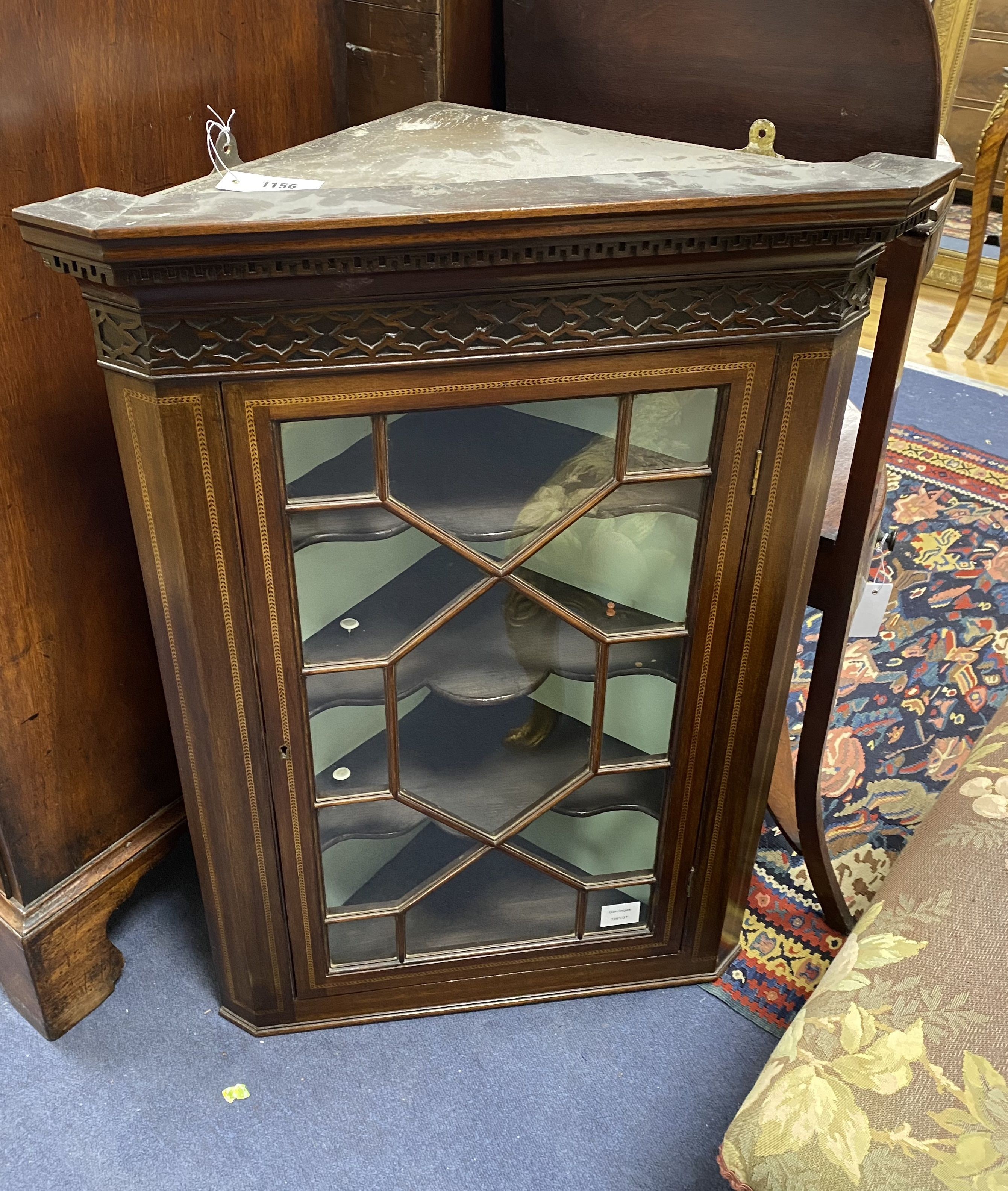 A George III style mahogany hanging corner cupboard, width 62cm, depth 35cm, height 87cm